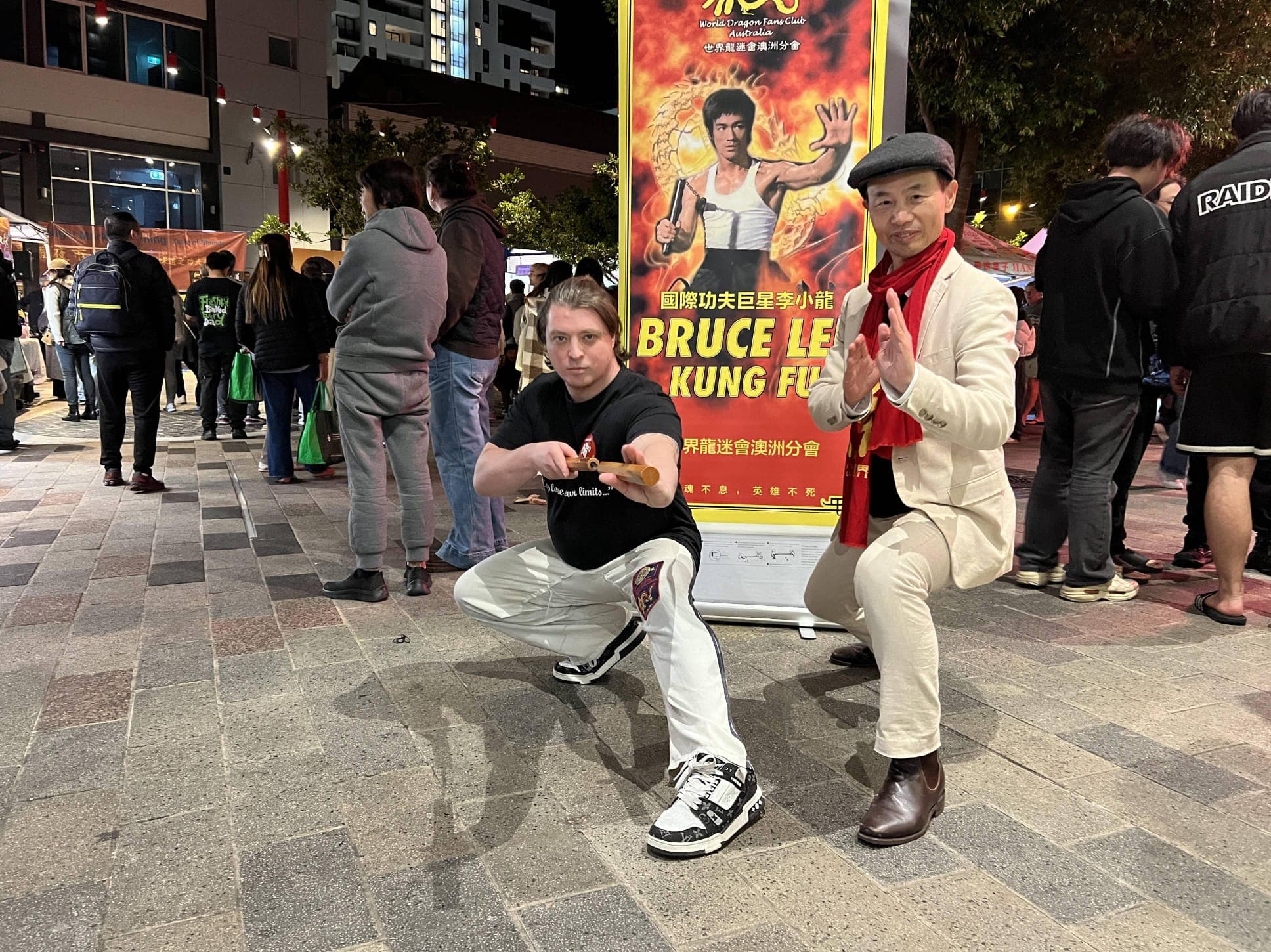 Sensei Brendon in a low stance with nunchaku at the Bruce Lee tribute event