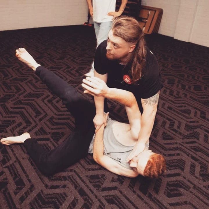 Sensei Brendon holding a ground control position over a training partner